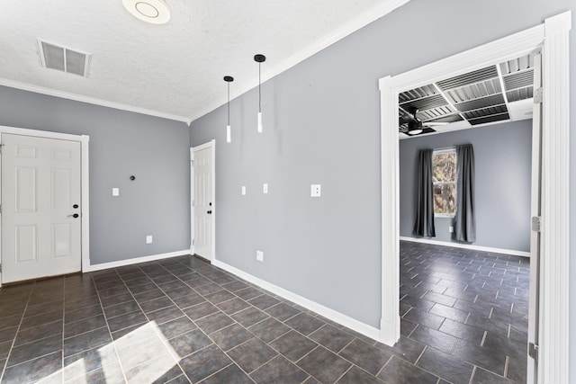 empty room with visible vents, a textured ceiling, crown molding, and baseboards