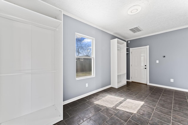 unfurnished bedroom with baseboards, visible vents, and a textured ceiling