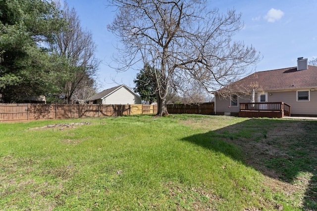 view of yard featuring fence and a wooden deck