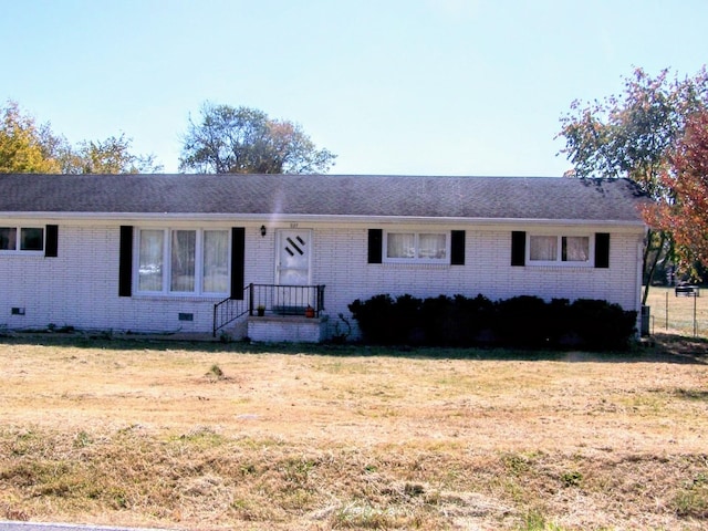 single story home with crawl space, brick siding, and a front yard