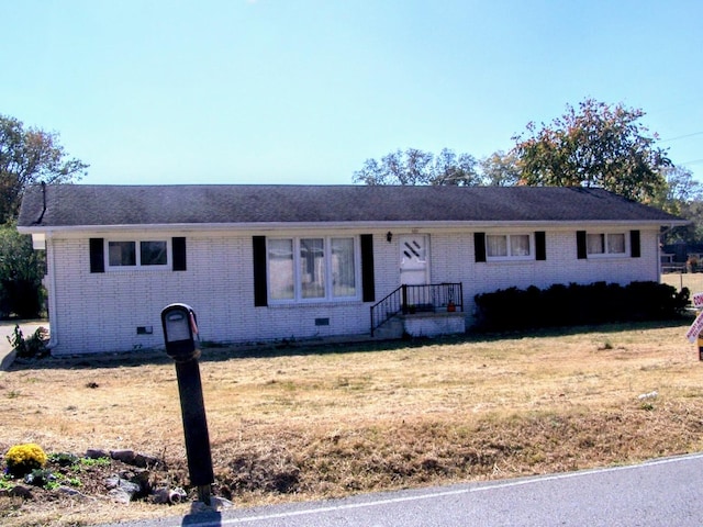 single story home with brick siding, crawl space, and a front yard