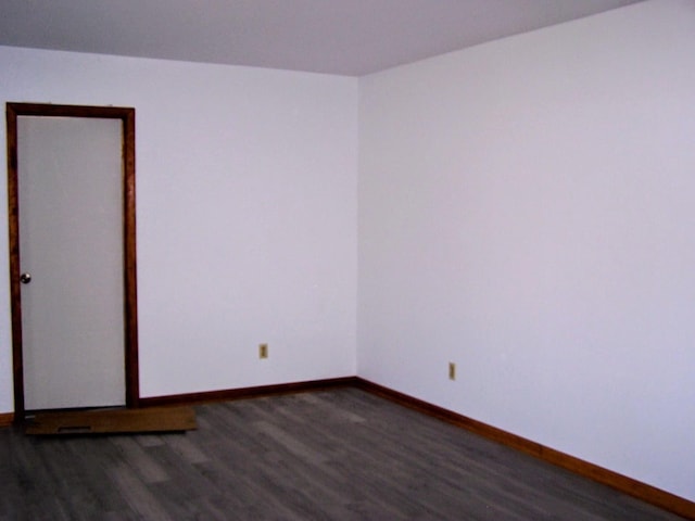 unfurnished room featuring wood finished floors and baseboards