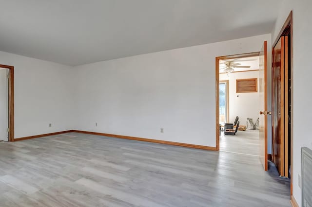 unfurnished room featuring baseboards and wood finished floors