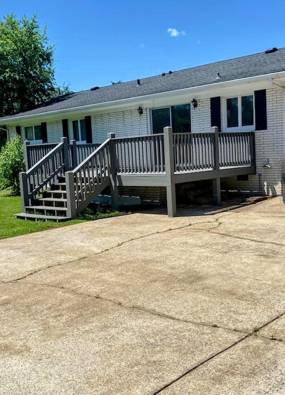 927 E Jefferson St, Pulaski, TN 38478 - view of front facade with brick siding and a wooden deck
