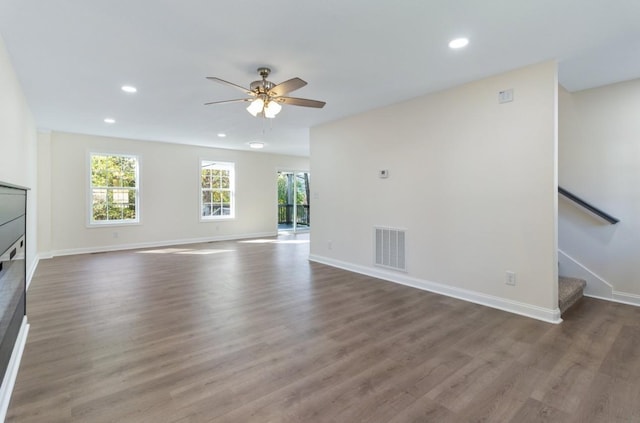 unfurnished living room featuring visible vents, wood finished floors, recessed lighting, stairway, and ceiling fan