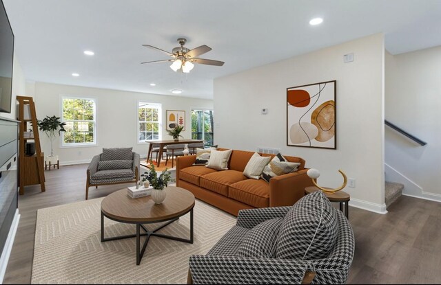 living room featuring stairway, recessed lighting, baseboards, and wood finished floors