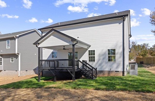 back of house featuring stairway, ceiling fan, crawl space, a deck, and a lawn