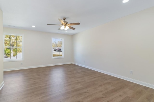 spare room with recessed lighting, a ceiling fan, baseboards, and wood finished floors