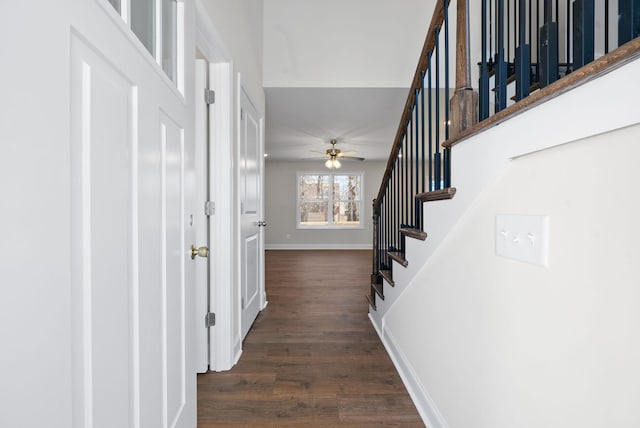 corridor with stairway, baseboards, and dark wood finished floors