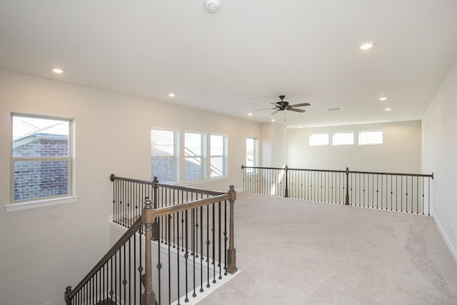 corridor with plenty of natural light and recessed lighting