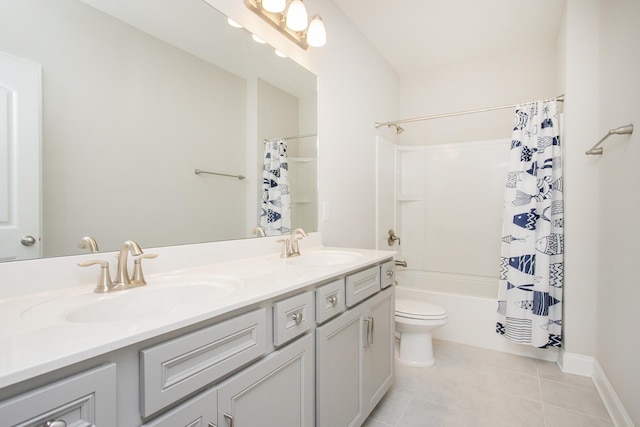 bathroom featuring a sink, toilet, double vanity, and tile patterned floors