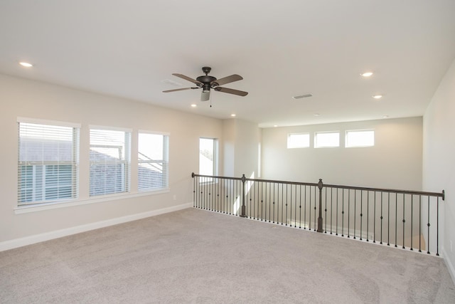 spare room with a wealth of natural light, recessed lighting, carpet, and baseboards