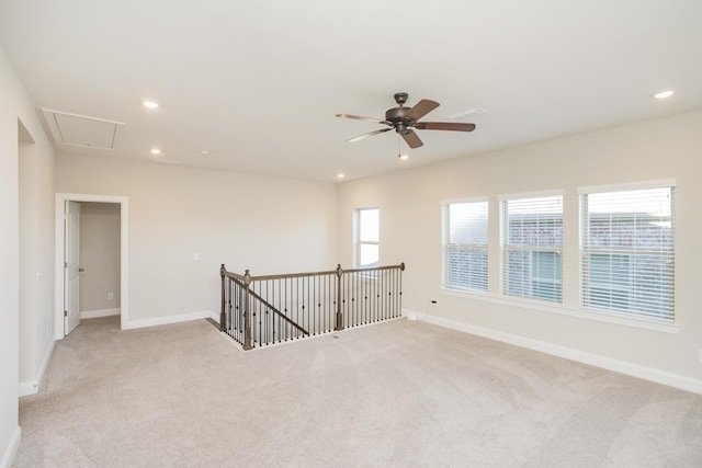 empty room with recessed lighting, baseboards, and light carpet