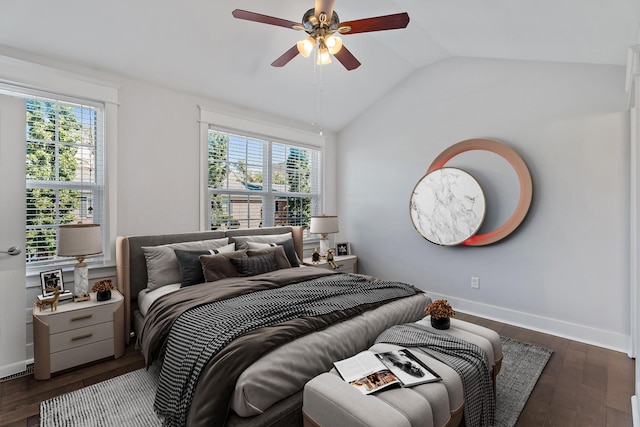 bedroom featuring baseboards, multiple windows, hardwood / wood-style floors, and vaulted ceiling