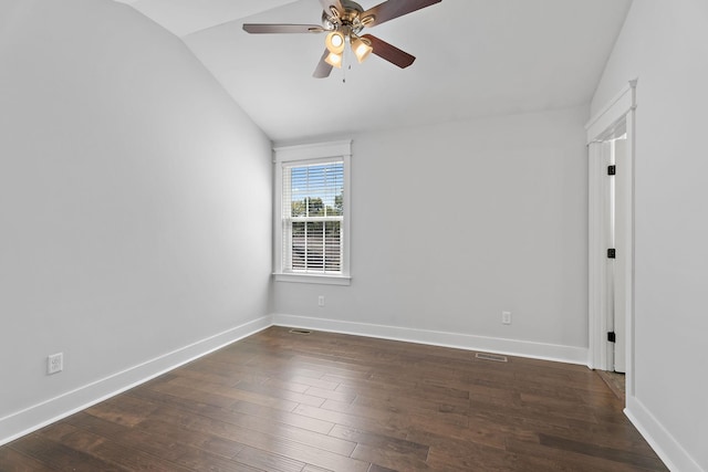 empty room with visible vents, baseboards, ceiling fan, dark wood-style flooring, and vaulted ceiling