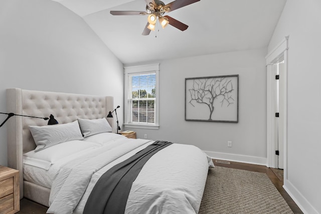 bedroom with dark wood-style flooring, ceiling fan, baseboards, and vaulted ceiling