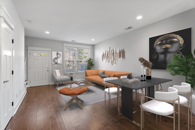 living area with visible vents, recessed lighting, and wood finished floors