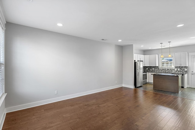 interior space with recessed lighting, visible vents, baseboards, and dark wood-style flooring