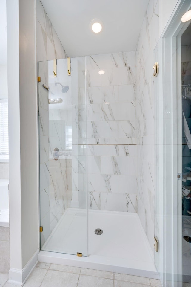 bathroom featuring a marble finish shower