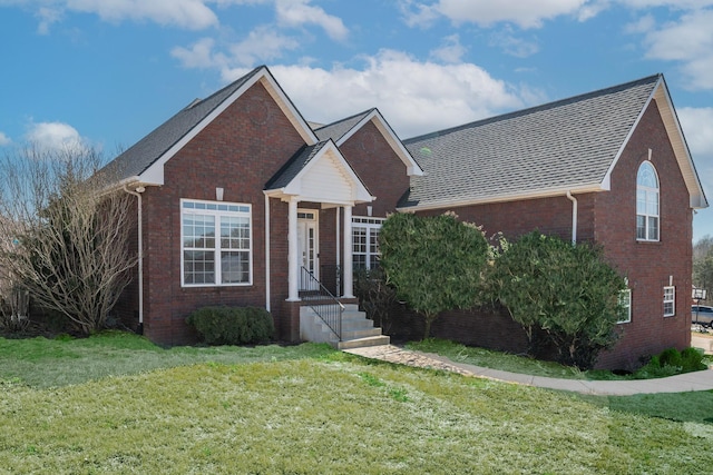 view of front of house with a front lawn and brick siding