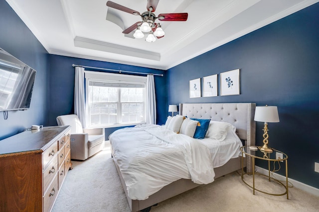 bedroom featuring crown molding, ceiling fan, baseboards, a tray ceiling, and light carpet