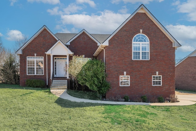 traditional-style house featuring brick siding and a front yard