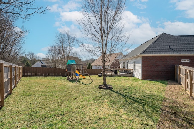 view of yard featuring a playground and a fenced backyard