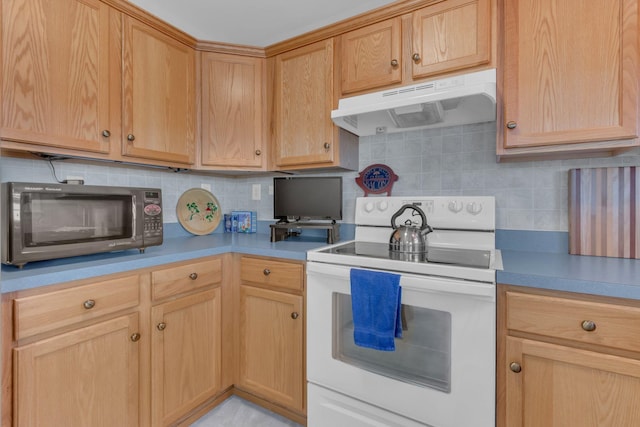 kitchen featuring under cabinet range hood, white range with electric stovetop, light countertops, and backsplash