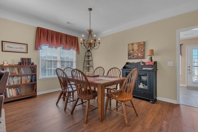 dining area with a wealth of natural light, visible vents, baseboards, and wood finished floors