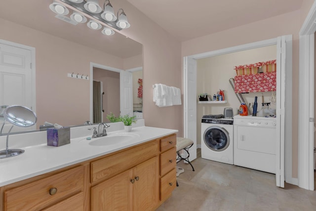 bathroom with independent washer and dryer and vanity