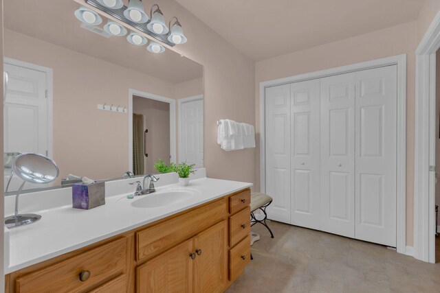 bathroom with vanity and a closet