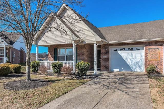 view of front of property with driveway, a porch, an attached garage, a shingled roof, and brick siding