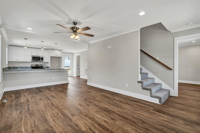 unfurnished living room featuring stairway, baseboards, dark wood finished floors, and crown molding