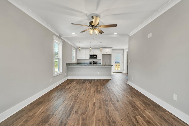 unfurnished living room with dark wood-style floors, baseboards, recessed lighting, ceiling fan, and ornamental molding