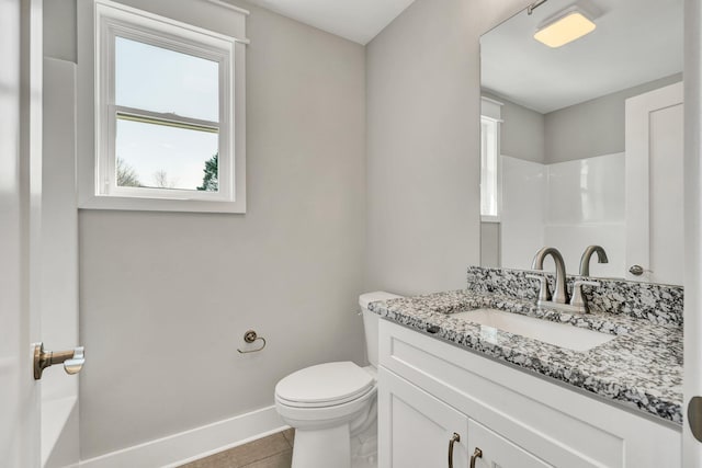 bathroom featuring tile patterned flooring, walk in shower, baseboards, toilet, and vanity