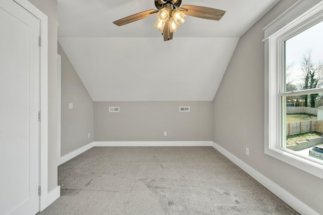 additional living space featuring carpet flooring, baseboards, visible vents, and a wealth of natural light