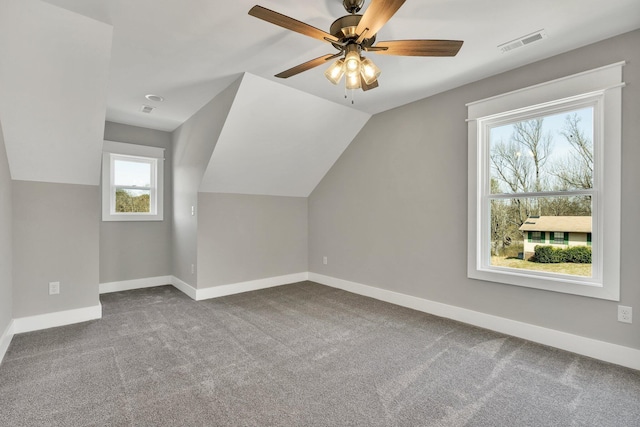 bonus room featuring lofted ceiling, carpet flooring, visible vents, and baseboards