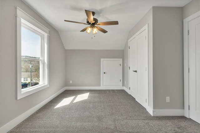 bonus room with baseboards, a ceiling fan, lofted ceiling, and carpet