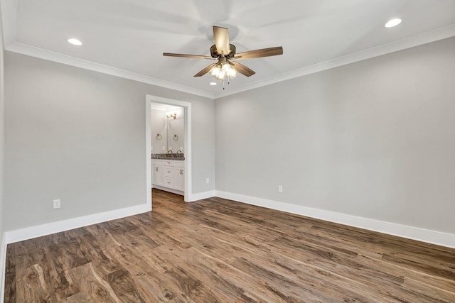 spare room featuring a ceiling fan, recessed lighting, crown molding, baseboards, and dark wood-style flooring