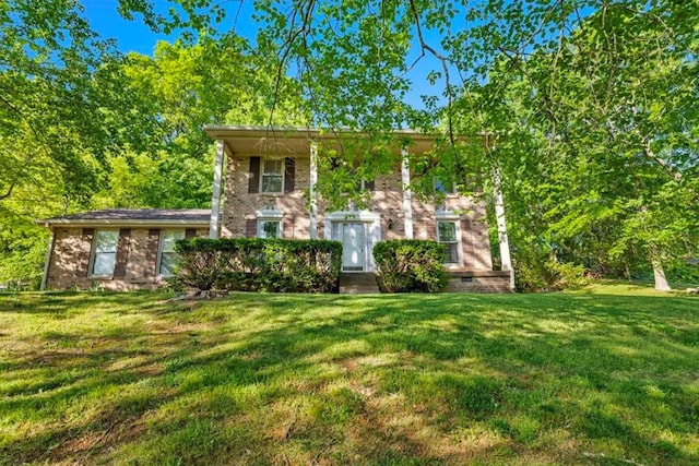 view of front facade featuring brick siding and a front lawn