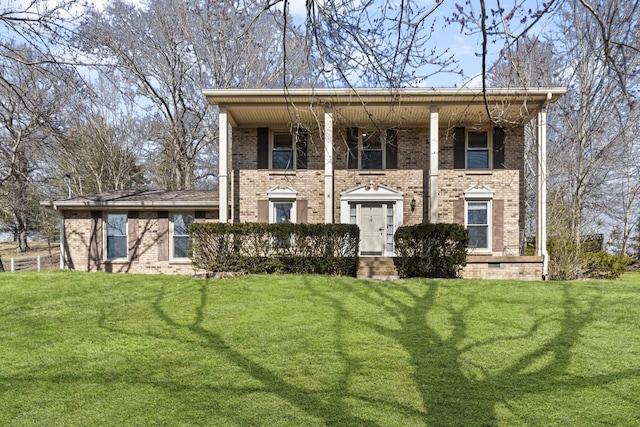 neoclassical home featuring brick siding and a front lawn