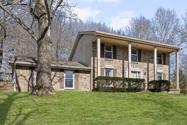 view of front of home featuring a front yard and brick siding