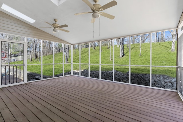 wooden deck featuring a ceiling fan and a yard
