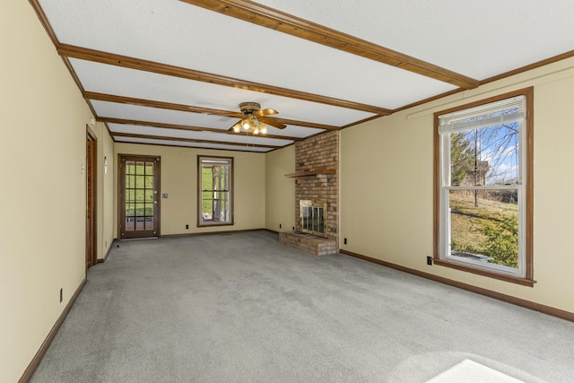 unfurnished living room with beam ceiling, light carpet, a healthy amount of sunlight, and a fireplace