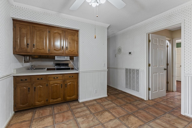 kitchen with visible vents, wainscoting, and wallpapered walls