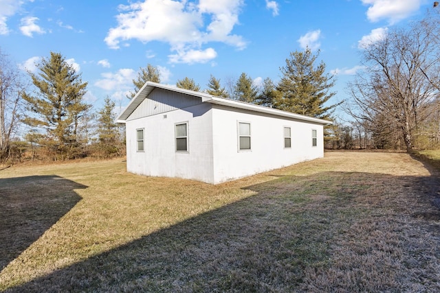 view of side of home featuring a lawn