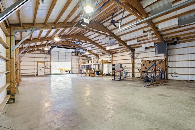 garage featuring a garage door opener and metal wall