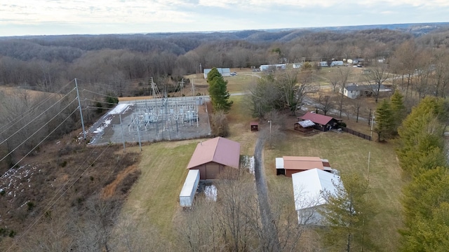 drone / aerial view featuring a wooded view