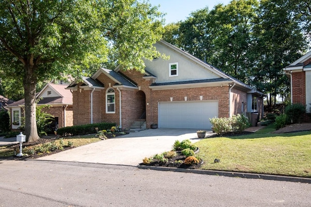 view of front of house with driveway, brick siding, and a front lawn