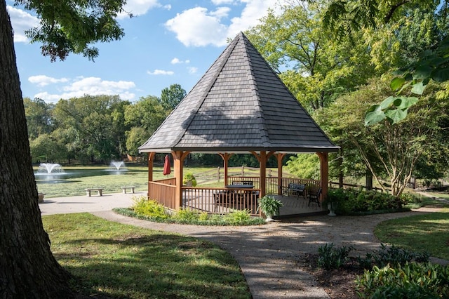 view of home's community with a gazebo, a yard, and a water view